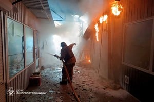 A firefighter works at a street market hit by a Russian drone strike, amid Russia's attack on Ukraine, in Nikopol, Ukraine, April 4, 2026. Press service of the State Emergency Service of Ukraine in Dnipropetrovsk region/Handout via REUTERS ATTENTION EDITORS - THIS IMAGE HAS BEEN SUPPLIED BY A THIRD PARTY. LOGO FROM SOURCE. MANDATORY CREDIT. BEST QUALITY AVAILABLE.
