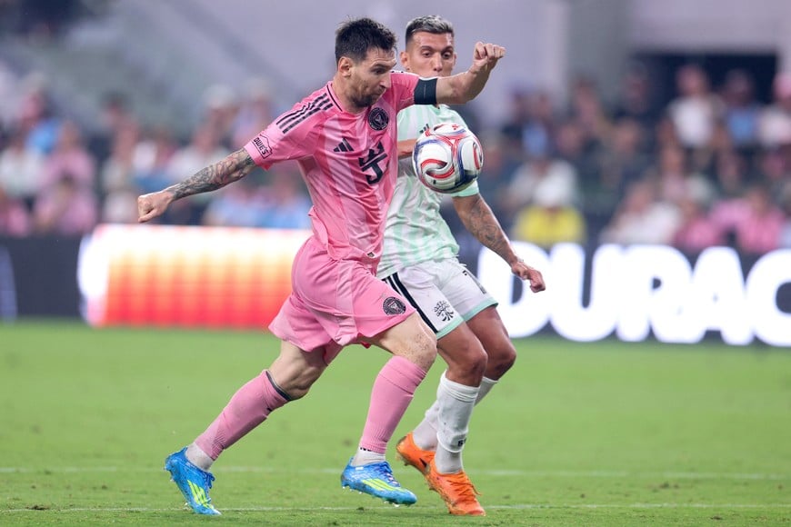 Apr 4, 2026; Miami, Florida, USA; Inter Miami CF forward Lionel Messi (10) goes after the ball defended by Austin FC forward Myrto Uzuni (10) during the second half at Nu Stadium. Mandatory Credit: Nathan Ray Seebeck-Imagn Images