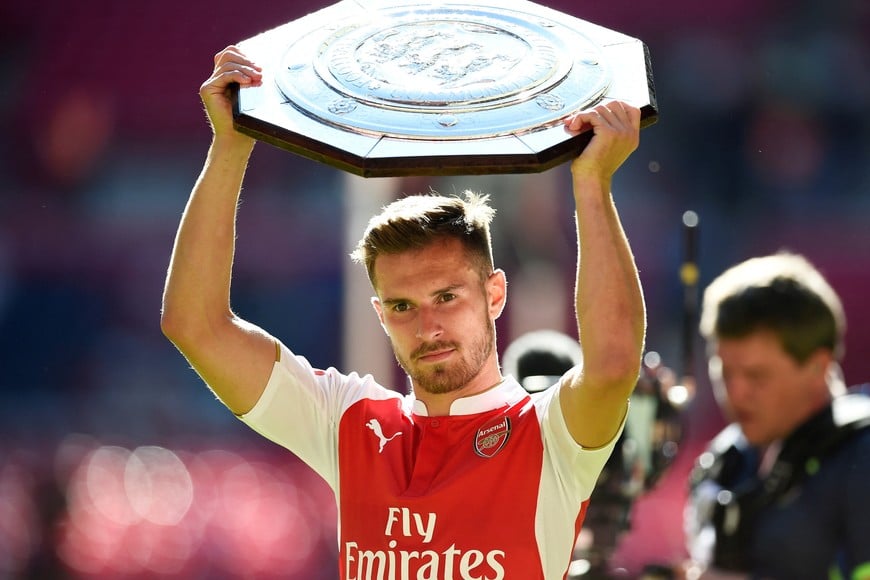 FILE PHOTO: Football - Chelsea v Arsenal - FA Community Shield - Wembley Stadium - 2/8/15
Arsenal's Aaron Ramsey celebrates with the trophy after winning the FA Community Shield
Reuters / Dylan Martinez
Livepic
EDITORIAL USE ONLY. No use with unauthorized audio, video, data, fixture lists, club/league logos or "live" services. Online in-match use limited to 45 images, no video emulation. No use in betting, games or single club/league/player publications.  Please contact your account representative for further details./File Photo