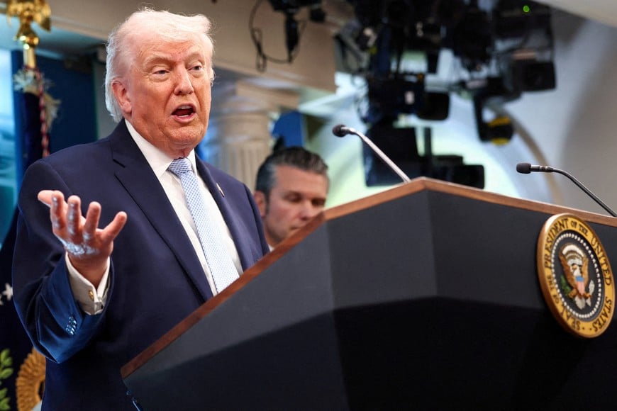 FILE PHOTO: U.S. President Donald Trump, flanked by Secretary of Defense Pete Hegseth, speaks during a press conference in the James S. Brady Press Briefing Room at the White House in Washington, D.C., U.S., April 6, 2026. REUTERS/Kevin Lamarque/File Photo