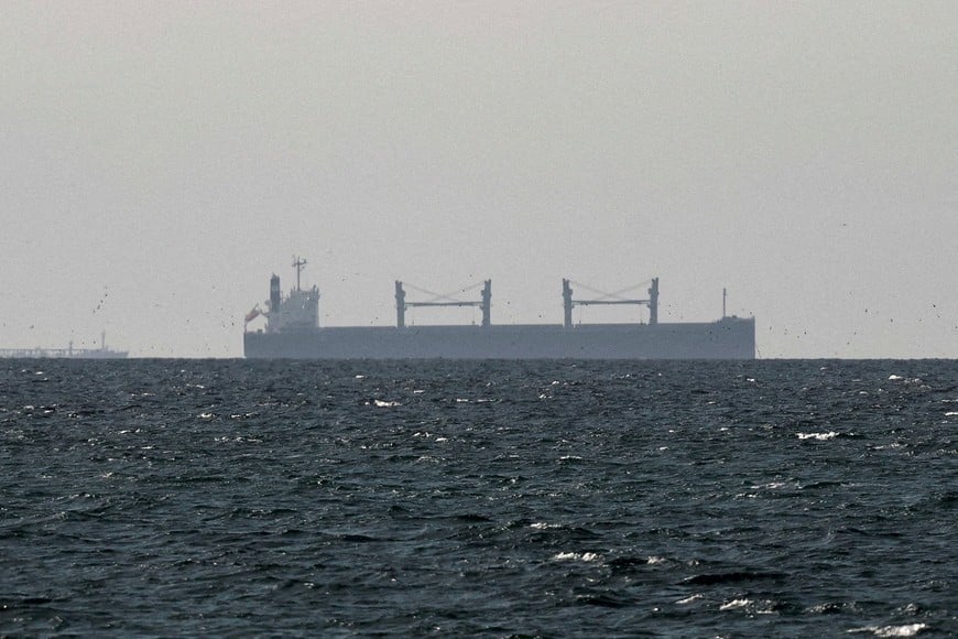 FILE PHOTO: A cargo ship in the Gulf, near the Strait of Hormuz, as seen from northern Ras al-Khaimah, near the border with Oman’s Musandam governance, amid the U.S.-Israeli conflict with Iran, in United Arab Emirates, March 11, 2026. REUTERS/Stringer/File Photo/File Photo/File Photo