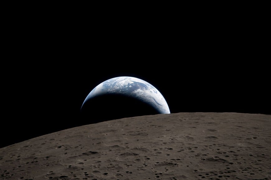 FILE PHOTO: A view of Earth, partially hidden behind the Moon, captured through the Orion spacecraft window at 6:41 p.m. EDT (22:41 GMT) April 6, 2026, during the Artemis II crew’s flyby of the Moon and obtained by Reuters on April 7, 2026. According to the image file data the picture was taken with a Nikon D5 camera and 400mm lens.      NASA/Handout via REUTERS. 
THIS IMAGE HAS BEEN SUPPLIED BY A THIRD PARTY/File Photo