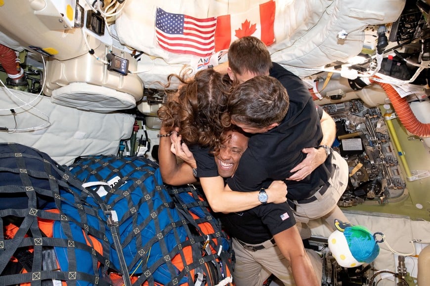 The NASA Artemis II crew, Mission Specialist Christina Koch, Mission Specialist Jeremy Hansen, Commander Reid Wiseman, and Pilot Victor Glover, embrace inside the Orion spacecraft on their way home following a flyby of the far side of the Moon on April 7, 2026. NASA/Handout via REUTERS THIS IMAGE HAS BEEN SUPPLIED BY A THIRD PARTY. REFILE - CORRECTING DATE FROM "APRIL 6" TO "APRIL 7". TPX IMAGES OF THE DAY