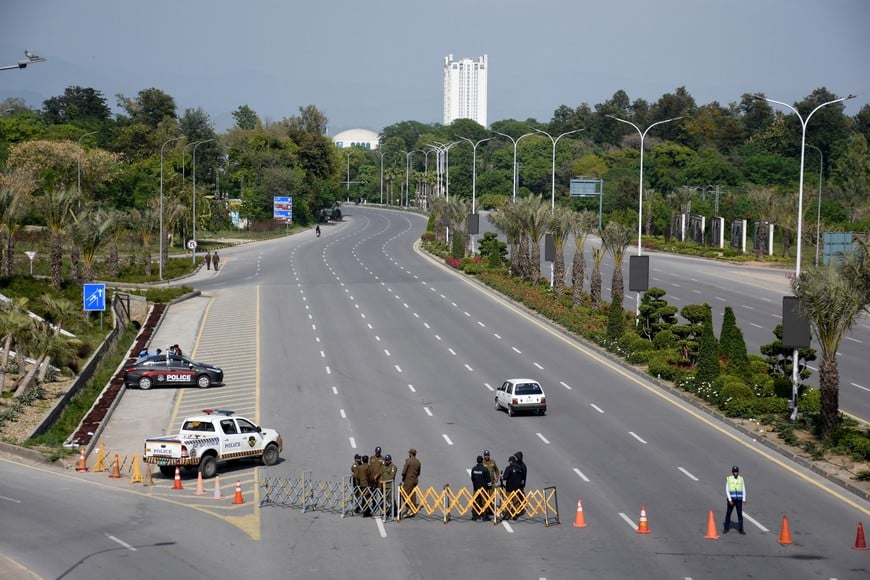 Members of security personnel stand guard on a road leading to the Serena Hotel as delegations from the United States and Iran are expected to hold peace talks, in Islamabad, Pakistan, April 11, 2026. REUTERS/Waseem Khan
