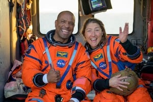 NASA astronaut Victor Glover, Artemis II pilot, and NASA astronaut Christina Koch, Artemis II mission specialist react while sitting on a Navy MH-60 Seahawk from Helicopter Sea Combat Squadron (HSC) 23 on the flight deck of USS John P. Murtha after they and fellow crewmates were extracted from their Orion spacecraft after splashdown, in the Pacific Ocean off the coast of California, U.S. April 10, 2026. NASA/Bill Ingalls/Handout via REUTERS    THIS IMAGE HAS BEEN SUPPLIED BY A THIRD PARTY     TPX IMAGES OF THE DAY