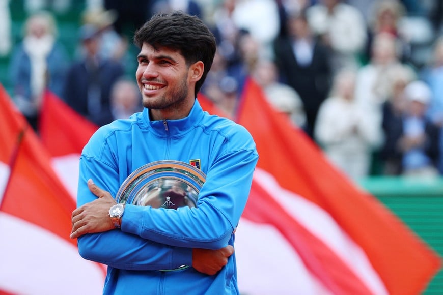 Tennis - ATP Masters 1000 - Monte Carlo Masters - Monte Carlo Country Club, Roquebrune-Cap-Martin, France - April 12, 2026
Spain's Carlos Alcaraz celebrates with the runners-up trophy after losing his final match against Italy's Jannik Sinner REUTERS/Manon Cruz