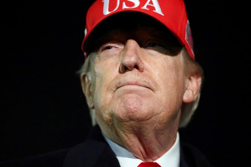 U.S. President Donald Trump looks on after disembarking Air Force One as he arrives at Joint Base Andrews in Maryland, U.S., April 12, 2026.  REUTERS/Kevin Lamarque
