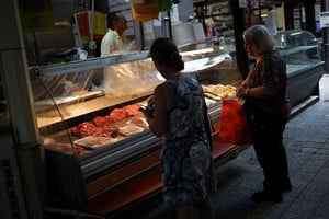 Costumers wait at the counter of a butcher shop in a local market, as Argentines ate more poultry per capita than beef in 2024, official data show that consumption of the red meat slid amid high inflation and tough austerity under libertarian President Javier Milei, in Buenos Aires, Argentina January 23, 2025. REUTERS/Agustin Marcarian
