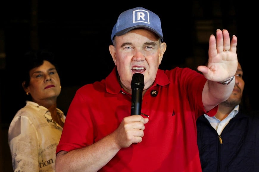 Peru's presidential candidate Rafael Lopez Aliaga speaks as people gather outside Peru's electoral headquarters amid concerns about the voting process during the country's general election, in Lima, Peru, April 14, 2026. REUTERS/Manuel Orbegozo