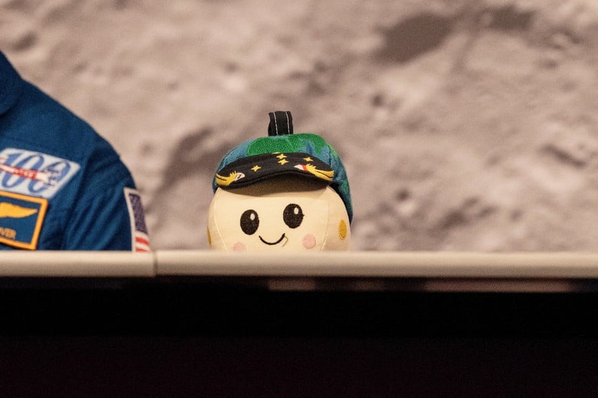 A plush moon sits on the table while the four-member crew of the Artemis II Moon mission's Orion capsule speak during a press conference at NASA's Johnson Space Centre in Houston, Texas, U.S., April 16, 2026.  REUTERS/Lexi Parra