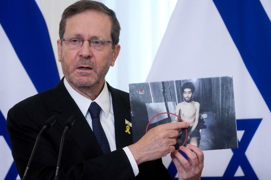 FILE PHOTO: Israeli President Isaac Herzog shows a photo Israeli man Evyatar David, who is held hostage by Hamas, as he speaks during a press conference with Latvian President Edgars Rinkevics in Riga, Latvia August 5, 2025. REUTERS/Ints Kalnins/File Photo