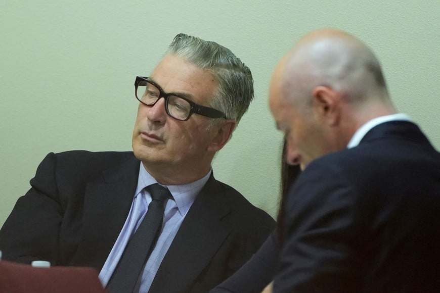FILE PHOTO: US actor Alec Baldwin (L) attends his trial for involuntary manslaughter at Santa Fe County District Court in Santa Fe, New Mexico, on July 12, 2024. In October 2021, on the New Mexico set of the Western movie "Rust," a gun pointed by Baldwin discharged a live round, killing the film's cinematographer Halyna Hutchins and wounding its director.     RAMSAY DE GIVE/Pool via REUTERS/File Photo