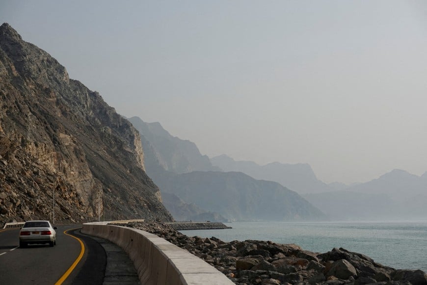 FILE PHOTO: A car rides along the coast of Musandam overlooking the Strait of Hormuz amid the U.S.-Israeli conflict with Iran, Oman, March 2, 2026.REUTERS/Amr Alfiky/File Photo