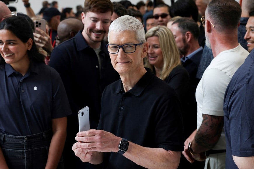 Apple CEO Tim Cook holds an iPhone Air, as Apple holds an event at the Steve Jobs Theater on its campus in Cupertino, California, U.S. September 9, 2025. REUTERS/Manuel Orbegozo