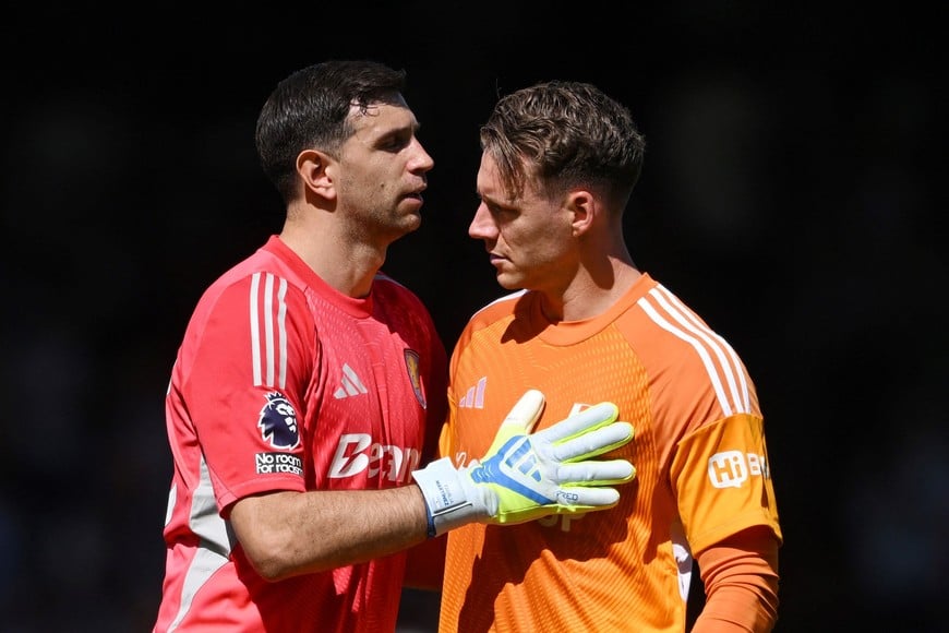 Soccer Football - Premier League - Fulham v Aston Villa - Craven Cottage, London, Britain - April 25, 2026
Aston Villa's Emiliano Martinez with Fulham's Bernd Leno after the match REUTERS/Jaimi Joy EDITORIAL USE ONLY. NO USE WITH UNAUTHORIZED AUDIO, VIDEO, DATA, FIXTURE LISTS, CLUB/LEAGUE LOGOS OR 'LIVE' SERVICES. ONLINE IN-MATCH USE LIMITED TO 120 IMAGES, NO VIDEO EMULATION. NO USE IN BETTING, GAMES OR SINGLE CLUB/LEAGUE/PLAYER PUBLICATIONS. PLEASE CONTACT YOUR ACCOUNT REPRESENTATIVE FOR FURTHER DETAILS..