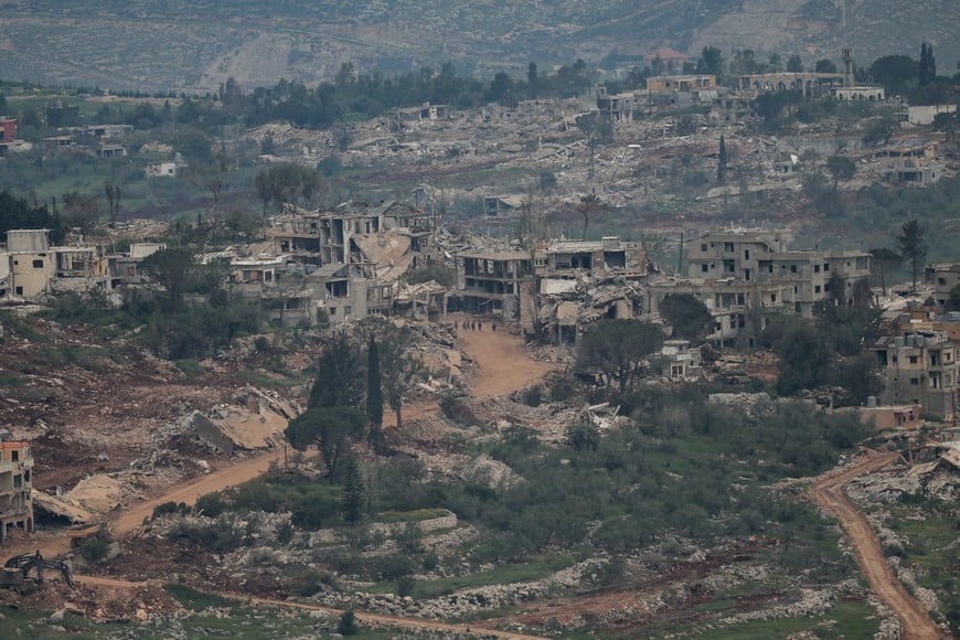 Israeli soldiers walk amid destroyed buildings in Lebanon, as seen from the Israeli side of the Israel-Lebanon border, in northern Israel, April 26, 2026. REUTERS/Shir Torem