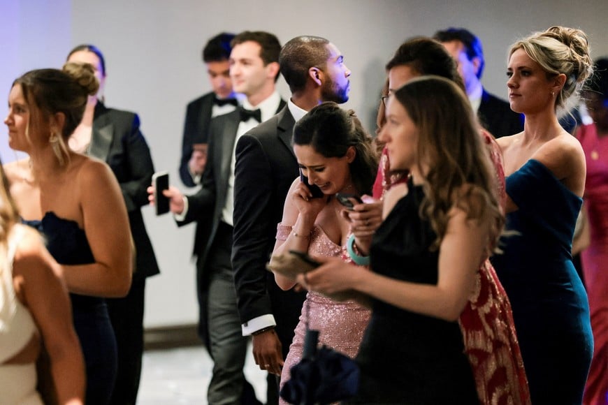 A guest reacts as she makes a phone call following a shooting incident during the annual White House Correspondents’ Association dinner in Washington, D.C., U.S., April 25, 2026 REUTERS/Jonathan Ernst