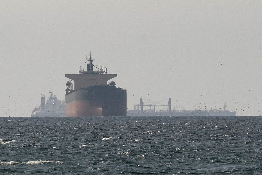 FILE PHOTO: Cargo ships in the Gulf, near the Strait of Hormuz, as seen from northern Ras al-Khaimah, near the border with Oman’s Musandam governance, amid the U.S.-Israeli conflict with Iran, in United Arab Emirates, March 11, 2026. REUTERS/Stringer/File Photo