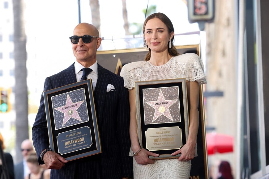 Actors Emily Blunt and Stanley Tucci pose with their stars' certificates on the Hollywood Walk of Fame in Los Angeles, California, U.S., April 30, 2026. REUTERS/Mario Anzuoni