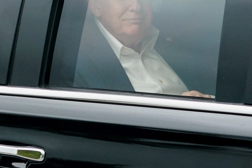 U.S. President Donald Trump looks on from inside a vehicle on his way to Miami International Airport in Florida, U.S., May 3, 2026. REUTERS/Nathan Howard