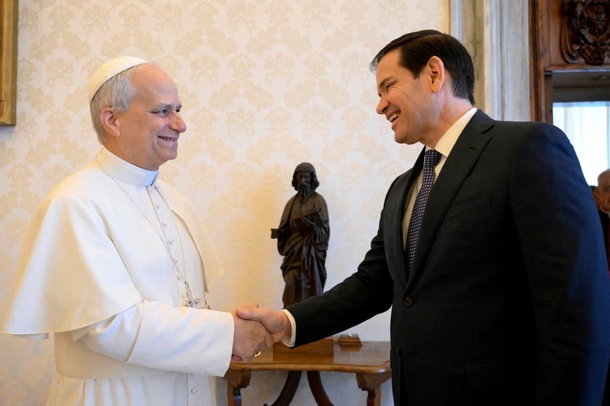 FILE PHOTO: Pope Leo XIV shakes hands with U.S. Secretary of State Marco Rubio as they meet at the Vatican, May 19, 2025. Vatican Media/­Simone Risoluti/Handout via REUTERS    ATTENTION EDITORS - THIS IMAGE WAS PROVIDED BY A THIRD PARTY./File Photo