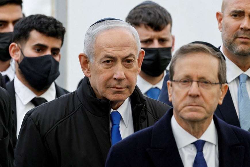 FILE PHOTO: Israeli Prime Minister Benjamin Netanyahu and Israeli President Isaac Herzog attend a memorial service held for Ran Gvili, an off-duty police officer who was killed fighting militants that had infiltrated Israel during the deadly October 7, 2023, attack by Hamas, and the last hostage recovered from Gaza, in Meitar, Israel, January 28, 2026. REUTERS/Amir Cohen/File Photo