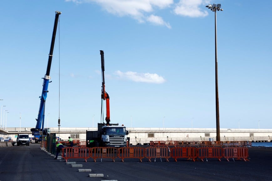 Workers prepare security measures at the port of Granadilla de Abona, Tenerife, Canary Islands, Spain, where the cruise ship MV Hondius affected by a deadly hantavirus outbreak is expected to arrive, May 8, 2026. REUTERS/Borja Suarez