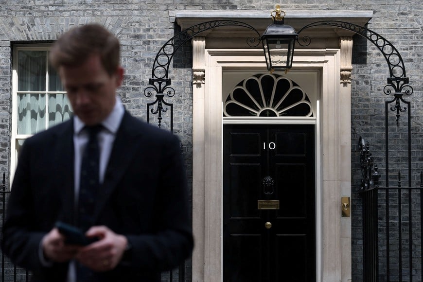 A journalist works in front of 10 Downing Street, the official residence of British Prime Minister, Keir Starmer, in London, Britain, May 9, 2026. REUTERS/Toby Melville