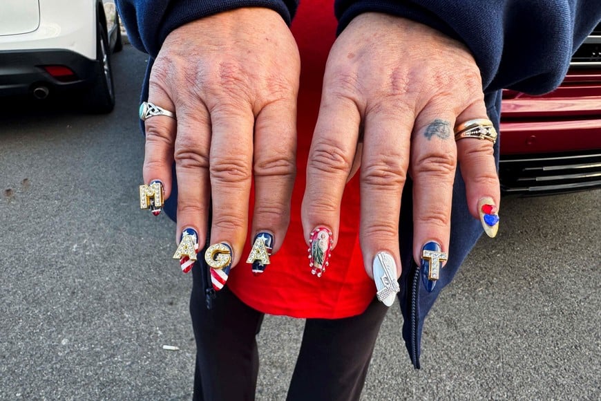 Laurie Sarver, a supporter of Republican presidential nominee former U.S. President Donald Trump, shows her "Make America Great Again" (MAGA) themed decorated nails outside a polling station during the 2024 U.S. presidential election on Election Day, in Cranberry Township, Pennsylvania, U.S., November 5, 2024. REUTERS/Kia Johnson