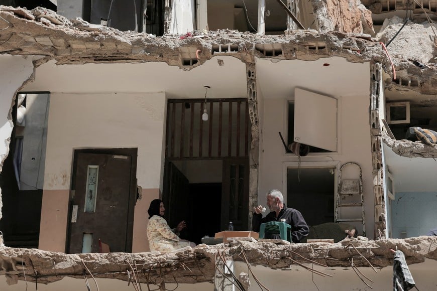 Ali Soueidan, 60, from southern Lebanon, drinks coffee with his wife in his damaged house, in the southern suburbs of Beirut, Lebanon, May 8, 2026. REUTERS/Raghed Waked     TPX IMAGES OF THE DAY