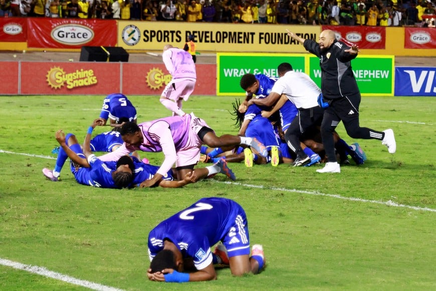 Soccer Football - FIFA World Cup - CONCACAF Qualifiers - Group B - Jamaica v Curacao - National Stadium Independence Park, Kingston, Jamaica - November 18, 2025
Curacao coach Dean Gorre and players celebrate after they qualify for the World Cup REUTERS/Gilbert Bellamy     TPX IMAGES OF THE DAY