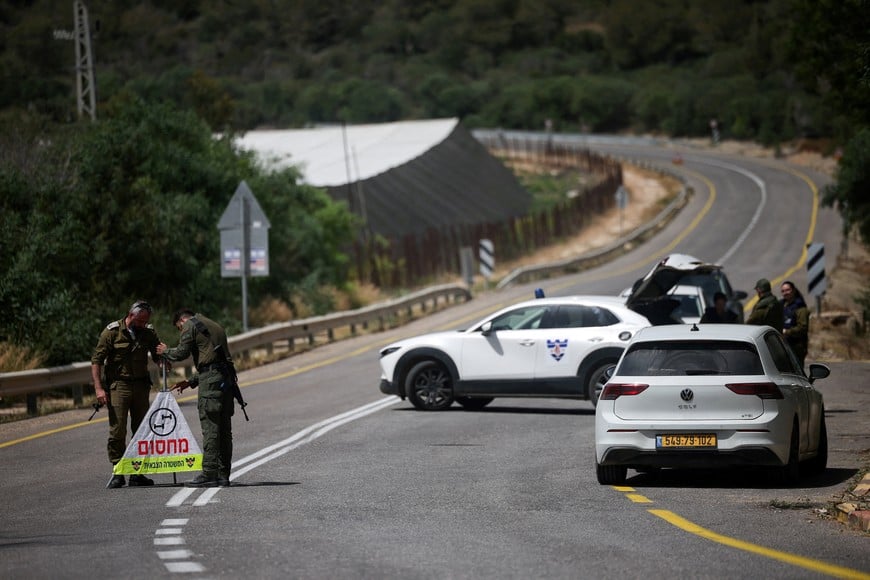 Soldiers set up a roadblock on the road leading to the tourist site of Rosh HaNikra in northern Israel, following a drone strike from Lebanon that injured three Israeli civilians according to the Israeli military, May 14, 2026. REUTERS/Shir Torem