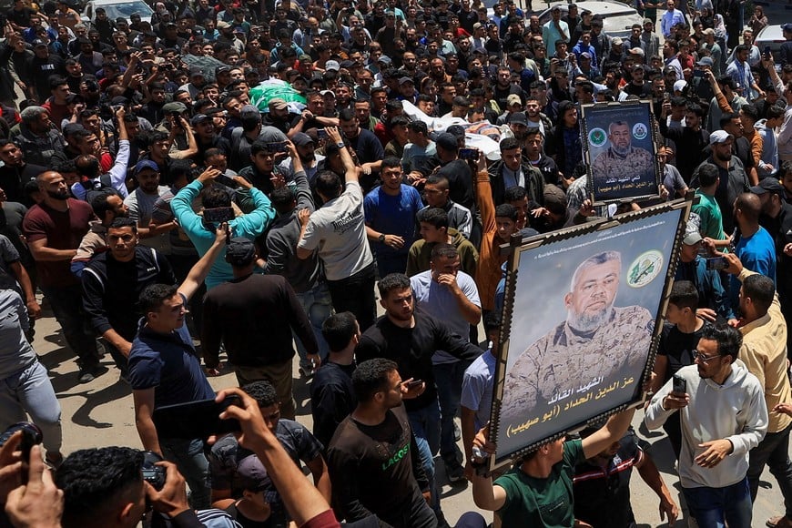 People carry images and bodies identified by mourners as Hamas' military wing commander Izz al-Din al-Haddad, his wife and his daughter, who were killed in an Israeli strike on Friday, during a funeral, in Gaza City, May 16, 2026. REUTERS/Dawoud Abu Alkas