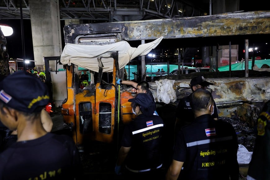 Emergency services work at a site where a train collided with a bus and several cars on Asok-Din Daeng Road, causing several casualties, in Bangkok, Thailand, May 16, 2026. REUTERS/Athit Perawongmetha