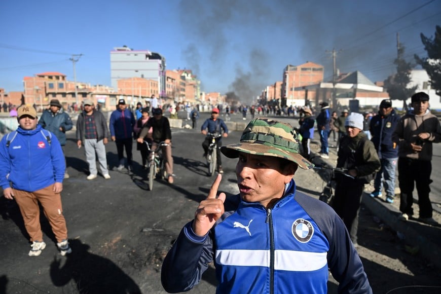 Smoke rises in the background as protesters demonstrate against President Rodrigo Paz's government amid an ongoing economic and fuel crisis, in El Alto, Bolivia, May 16, 2026. REUTERS/Claudia Morales