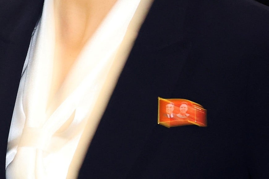 A member of North Korean soccer club Naegohyang Women’s FC wears a badge with portraits of North Korea’s founder Kim Il Sung and late leader Kim Jong Il as the team arrives at Incheon International Airport for a match against South Korea's Suwon FC Women on May 20, in Incheon, South Korea, May 17, 2026.     REUTERS/Kim Hong-Ji