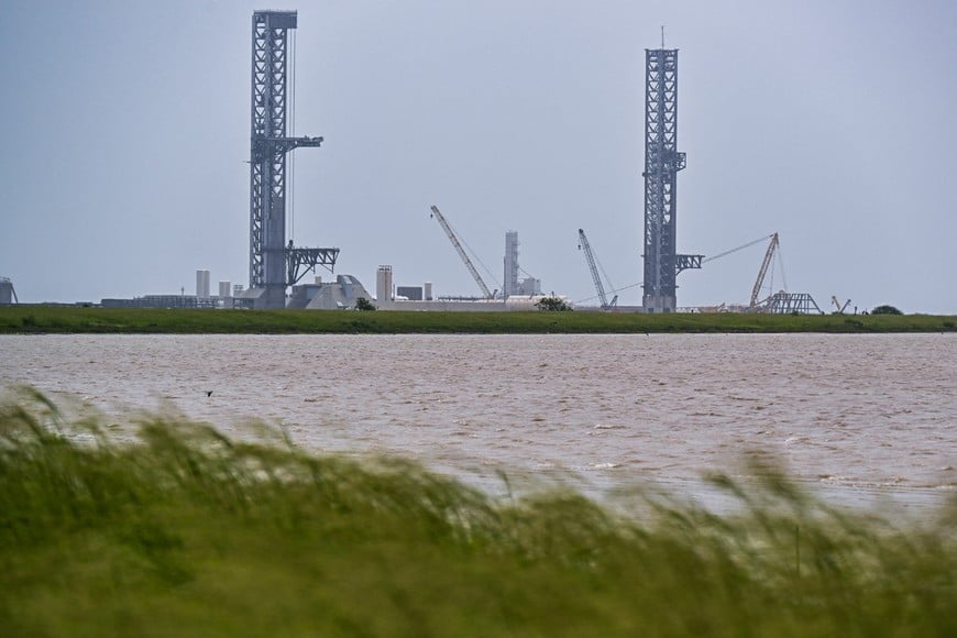 Preparations continue at launch pad 2, at left, for the 12th test flight of the Starship spacecraft and the Super Heavy booster in Starbase, Texas, U.S., May 16, 2026. In addition to being the inaugural voyage of both the V3 Starship and Super Heavy, the upcoming launch will mark the first blastoff from the new launch pad designed for the more powerful rocket. REUTERS/Steve Nesius