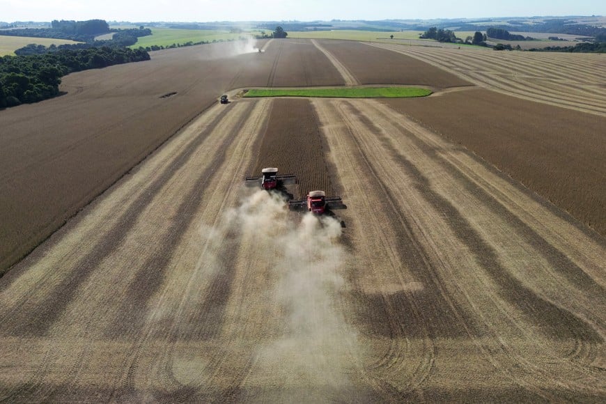 Rural workers operate harvesters during a record soybean harvest season in Brazil's southernmost state on a farm in Nao Me Toque, state of Rio Grande do Sul, Brazil, April 3, 2024. REUTERS/Diego Vara