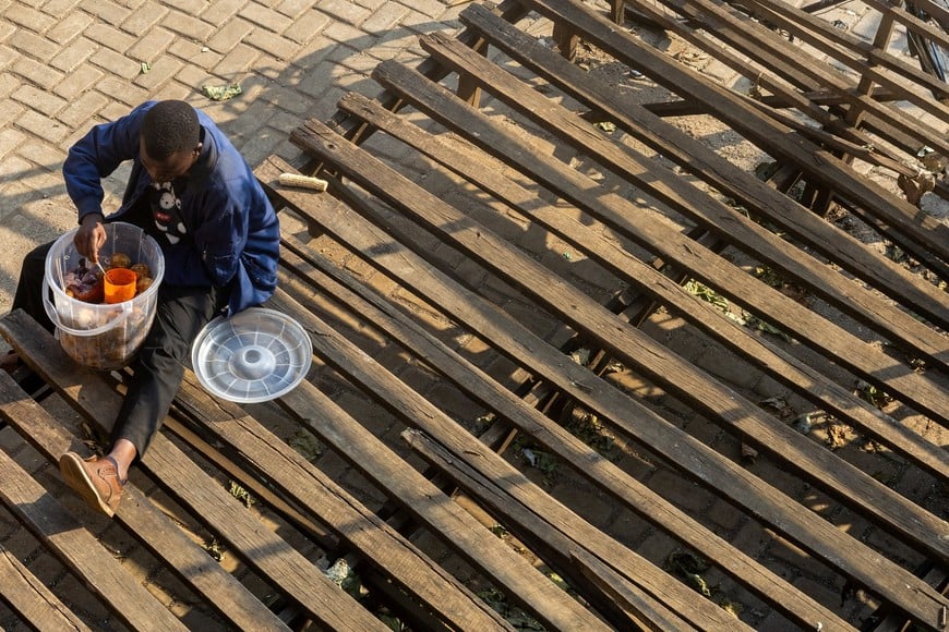 A trader snacks near the border crossing point in Gisenyi, as Rwanda tightens health screening following an Ebola outbreak caused by the Bundibugyo virus in DR Congo, Rubavu district, Rwanda, May 18, 2026. REUTERS/Jean Bizimana