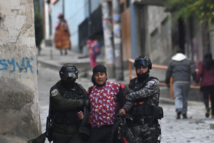 Police officers detain a person after clashes during a march calling for the resignation of Bolivia's President Rodrigo Paz, as the country's economic and fuel crisis worsens due to a shortage of U.S. dollars and falling domestic energy production, in La Paz, Bolivia May 18, 2026. REUTERS/Claudia Morales