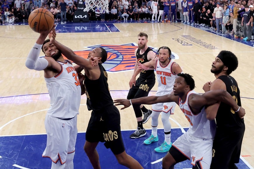 May 19, 2026; New York, New York, USA; New York Knicks center Karl-Anthony Towns (32) grabs a rebound against Cleveland Cavaliers center Evan Mobley (4) during the fourth quarter of game one of the eastern conference finals during the 2026 NBA playoffs at Madison Square Garden. Mandatory Credit: Brad Penner-Imagn Images