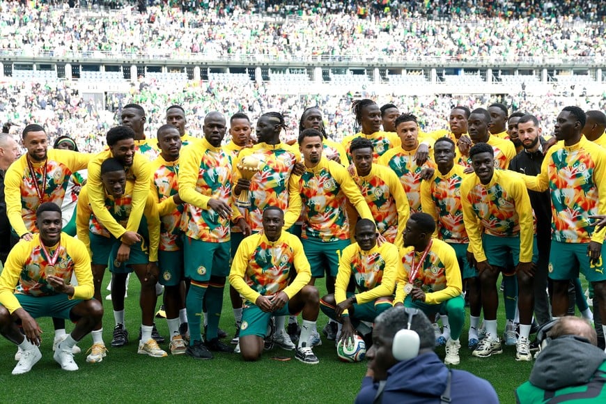 Soccer Football - International Friendly - Senegal v Peru - Stade de France, Saint-Denis, France - March 28, 2026
Senegal players celebrate with the CAF Africa Cup of Nations trophy before the match REUTERS/Stephanie Lecocq
