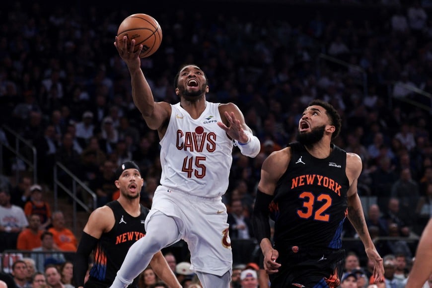 May 21, 2026; New York, New York, USA; Cleveland Cavaliers guard Donovan Mitchell (45) shoots against New York Knicks center Karl-Anthony Towns (32) during the second quarter of game two of the eastern conference finals of the 2026 NBA playoffs at Madison Square Garden. Mandatory Credit: Vincent Carchietta-Imagn Images