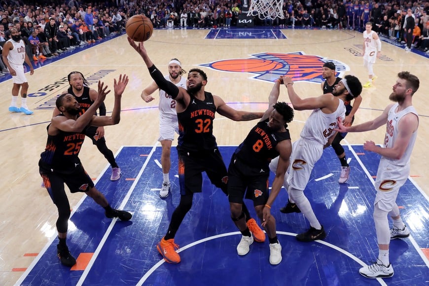 May 21, 2026; New York, New York, USA; New York Knicks center Karl-Anthony Towns (32) grabs a rebound against Cleveland Cavaliers guard Max Strus (2) and center Jarrett Allen (31) in front of Knicks guards Mikal Bridges (25) and Jalen Brunson (11) and forward OG Anunoby (8) during the third quarter of game two of the eastern conference finals during the 2026 NBA playoffs at Madison Square Garden. Mandatory Credit: Brad Penner-Imagn Images
