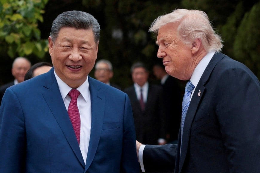 FILE PHOTO: U.S. President Donald Trump speaks with Chinese President Xi Jinping while leaving after a visit to the Zhongnanhai Garden in Beijing, China, May 15, 2026. REUTERS/Evan Vucci/Pool/File Photo