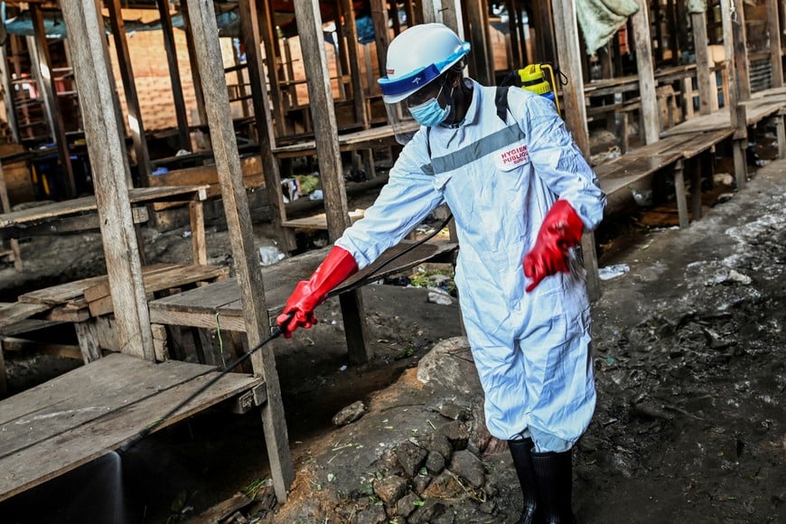 A sanitation worker from the Bunia city government sprays chlorine at the central market to limit the risk of the spread of the Ebola virus, as authorities intensify efforts to contain a new Ebola outbreak involving the Bundibugyo strain, in Bunia, Ituri province, Democratic Republic of Congo, May 23, 2026. REUTERS/Stringer