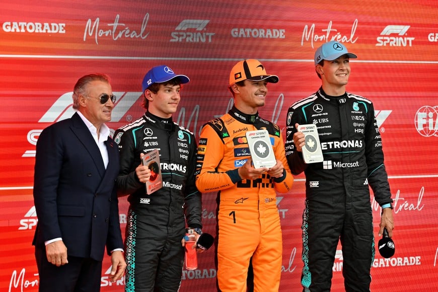Formula One F1 - Canadian Grand Prix -  Circuit Gilles Villeneuve, Montreal, Quebec, Canada - May 23, 2026
First place Mercedes' George Russell, second place McLaren's Lando Norris, and third place Mercedes' Andrea Kimi Antonelli pose with former Formula One driver Jean Alesi after the sprint race REUTERS/Jennifer Gauthier