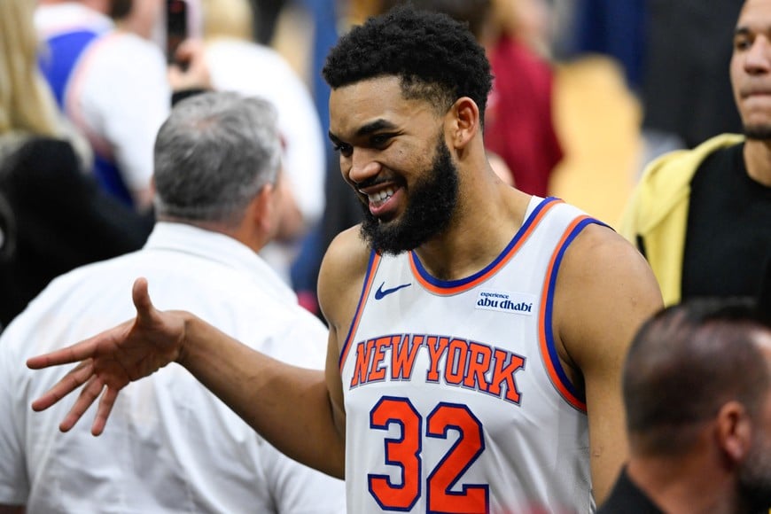May 23, 2026; Cleveland, Ohio, USA; New York Knicks center Karl-Anthony Towns (32)  high fives teammates after defeating the Cleveland Cavaliers in game three of the eastern conference finals for the 2026 NBA playoffs at Rocket Arena. Mandatory Credit: David Richard-Imagn Images