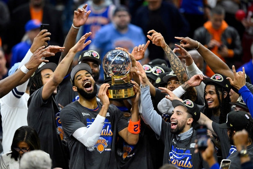 May 25, 2026; Cleveland, Ohio, USA; New York Knicks center Karl-Anthony Towns (32) lifts the 2026 Eastern Conference trophy with teammates after defeating the Cleveland Cavaliers in game four of the eastern conference finals for the 2026 NBA playoffs at Rocket Arena. Mandatory Credit: David Richard-Imagn Images TPX IMAGES OF THE DAY