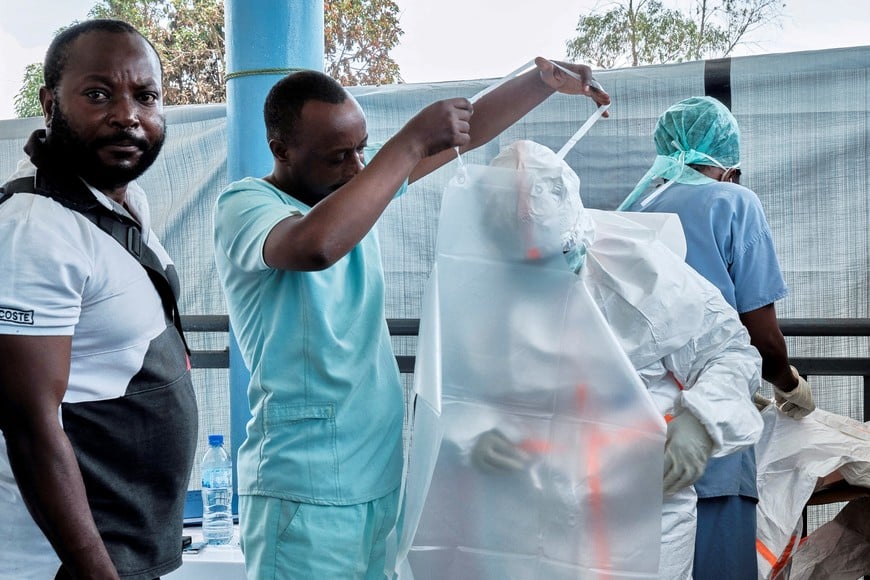 FILE PHOTO: Medical team from the Alliance for International Medical Action (ALIMA), an international NGO dress up in personal protective equipment (PPE) as they set up a treatment centre for the Ebola response, as agencies intensify efforts to contain a new Ebola outbreak caused by the Bundibugyo virus strain, in Rwampara outside Bunia, Ituri province, Democratic Republic of Congo, May 29, 2026. REUTERS/Gradel Muyisa Mumbere/File Photo